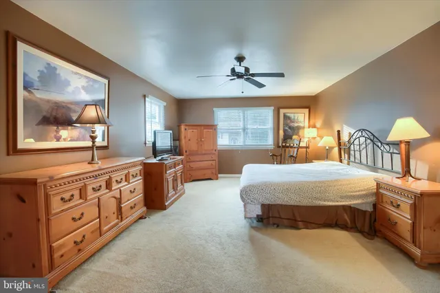 a spacious bedroom with a bed and a dresser