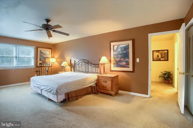 a bedroom with a bed lamps and window