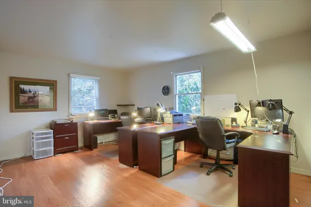 a view of a workspace with furniture and a window