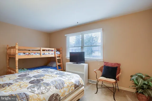 a bedroom with a bed and a chair