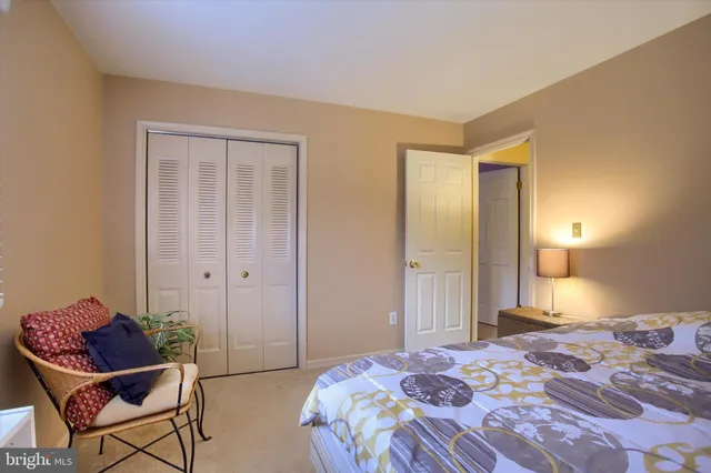 a bedroom with a bed and chair