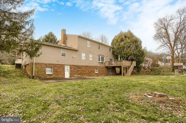 a white house that has a tree in front of it