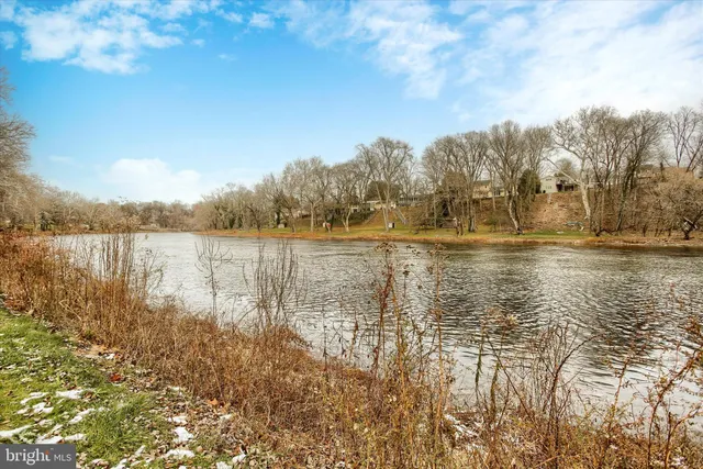 a front view of a house with a garden and yard