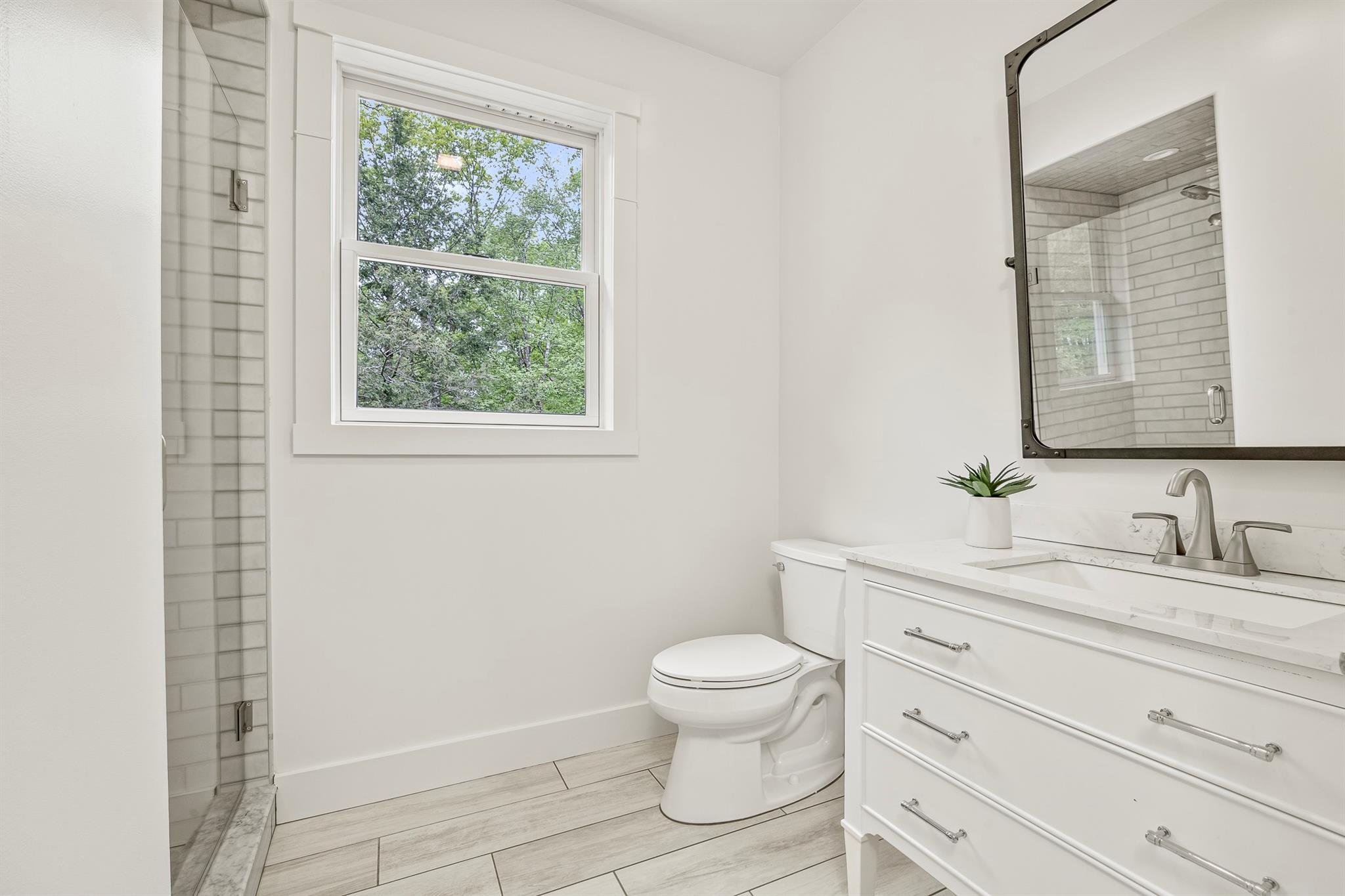 16 Anderson Road Pawling, NY 12564 - Photo 19 of 47 a bathroom with a granite countertop toilet a sink a mirror a window and vanity