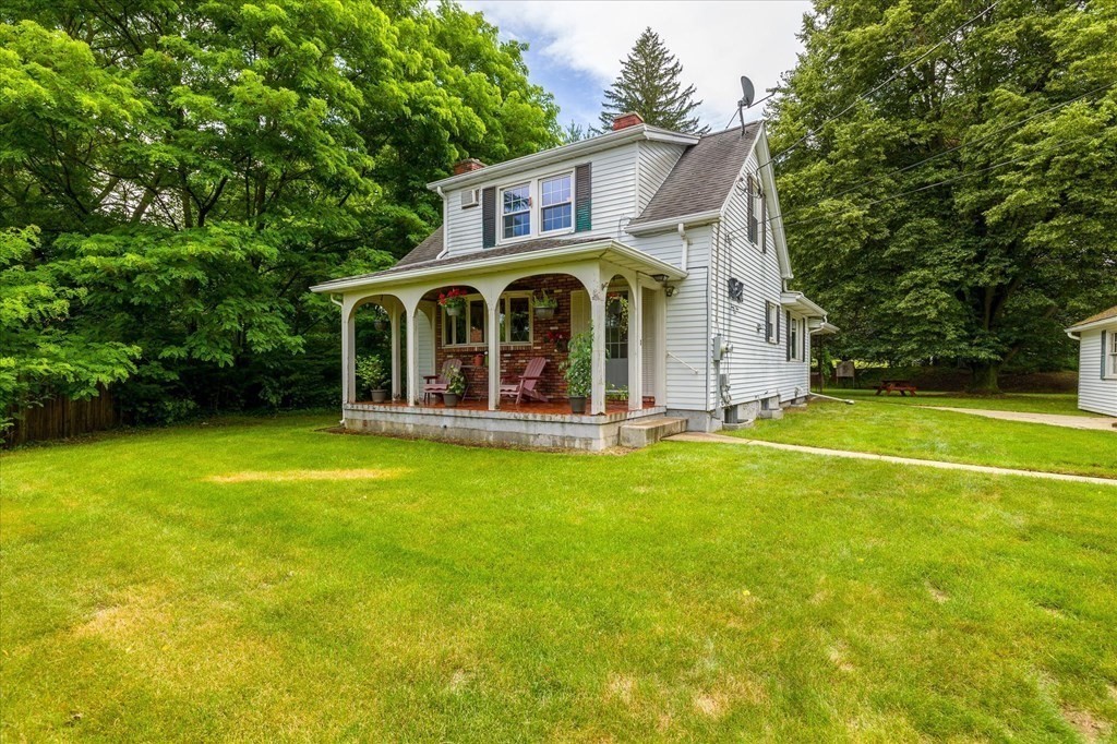 a front view of house with yard and green space