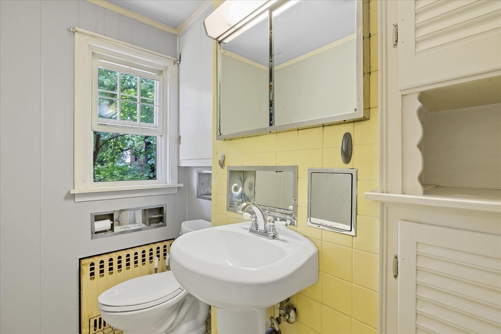 23 Fay Street Chicopee, MA 01020 - Photo 15 of 32 a bathroom with a sink a toilet and a mirror