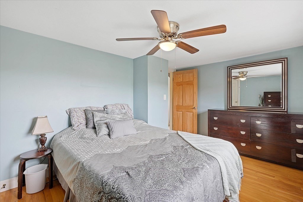 23 Fay Street Chicopee, MA 01020 - Photo 19 of 32 a bedroom with a bed and a chandelier