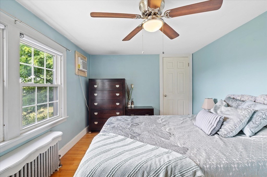 23 Fay Street Chicopee, MA 01020 - Photo 20 of 32 a bedroom with a bed chandelier and a window