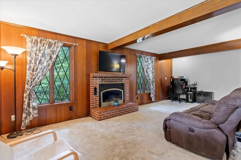 23 Fay Street Chicopee, MA 01020 - Photo 5 of 32 a living room with furniture a fireplace and a flat screen tv