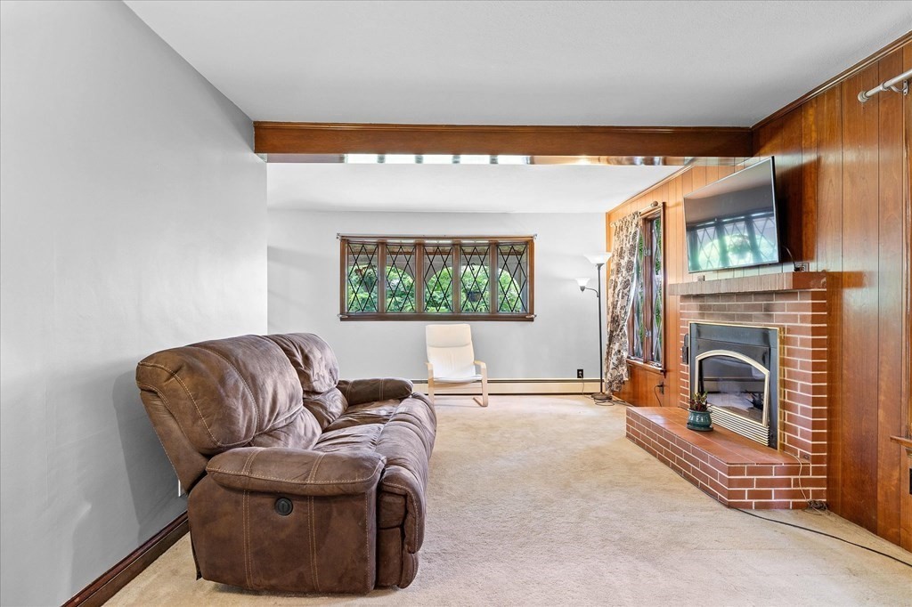 23 Fay Street Chicopee, MA 01020 - Photo 7 of 32 a living room with furniture a fireplace and a flat screen tv