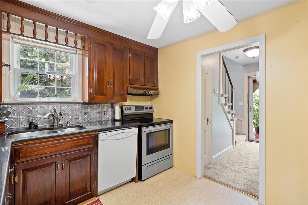 23 Fay Street Chicopee, MA 01020 - Photo 9 of 32 a kitchen with stainless steel appliances granite countertop a sink a stove and a refrigerator