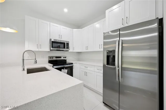 a kitchen with a refrigerator stove and microwave