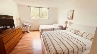 a bedroom with two beds and a flat screen tv