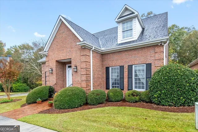 a kitchen with stainless steel appliances granite countertop a stove a sink dishwasher and a microwave oven with wooden floor