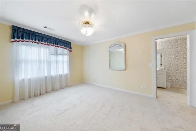 a view of a room with a ceiling fan and a window