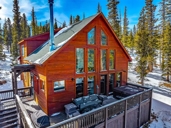 a view of a house with wooden fence