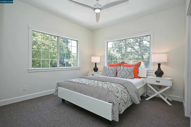 a bed sitting in a bedroom next to a window