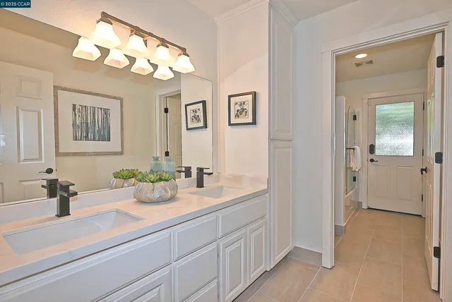 a view of a bedroom with a door and bench in wooden floor