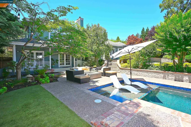 a view of a backyard with sitting area