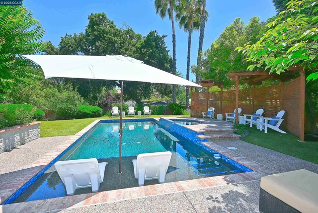 swimming pool view with a seating space