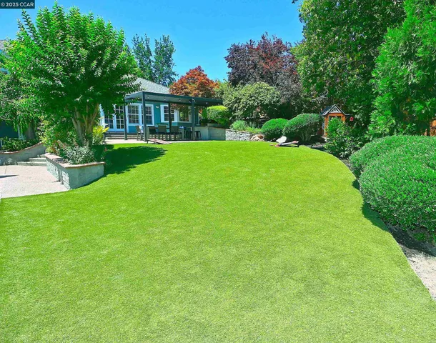 a view of a house with a yard patio and sitting area