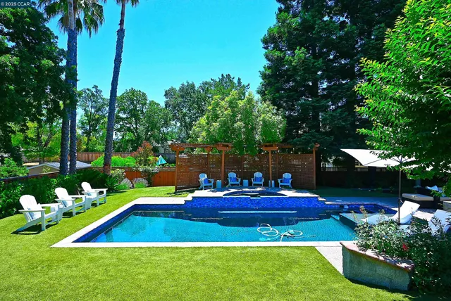 an aerial view of a houses with a yard and lake view