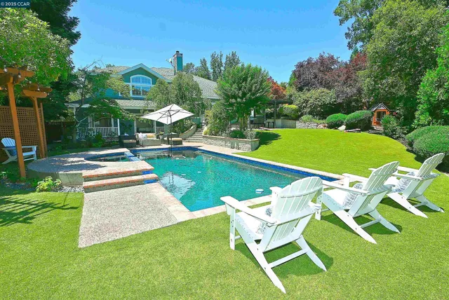 a view of a chairs and table under an umbrella