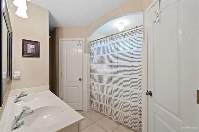 a bathroom with a tub shower and a sink