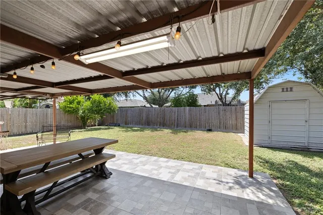 a backyard of a house with a garden and outdoor seating