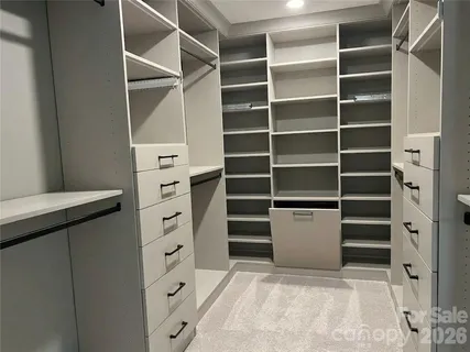 a bathroom with a granite countertop sink mirror and shower