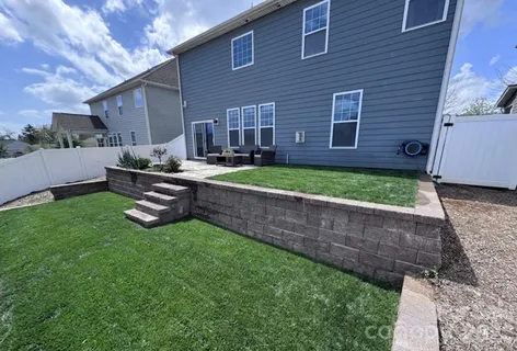 a backyard of a house with outdoor seating