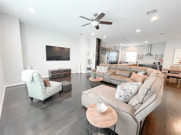 a large kitchen with kitchen island a large counter space stainless steel appliances and cabinets