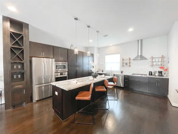 a large kitchen with a table and chairs