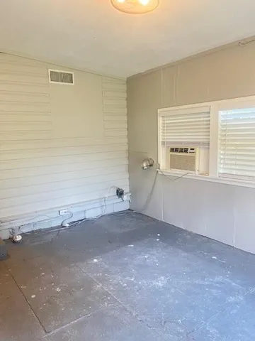 an empty room with an empty space and window