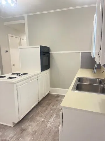 a kitchen with white cabinets and white appliances
