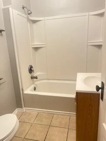 a bathroom with a bathtub and a toilet