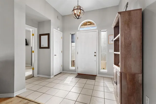 a view of a refrigerator in kitchen and entryway