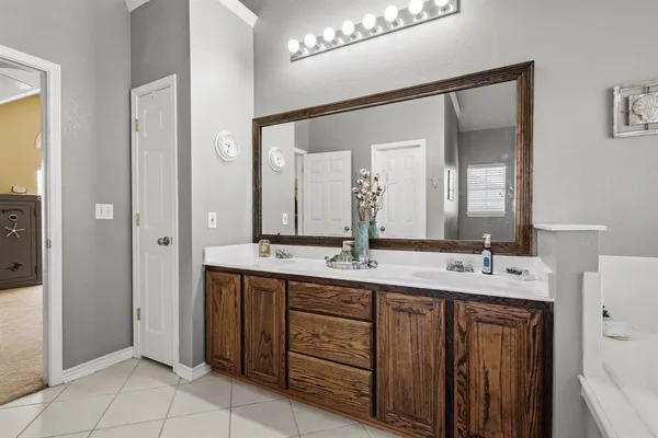 a bedroom with a bed mirror and a window