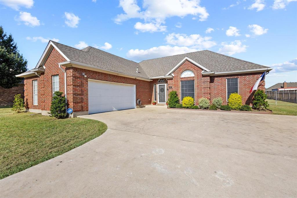 406 Sunshine Trail Bells, TX 75414 - Photo 2 of 37 a front view of a house with a garden and plants