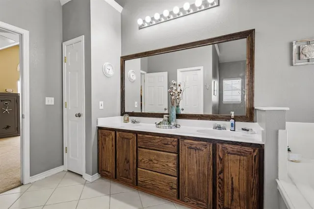 a bathroom with a double vanity sink and a mirror