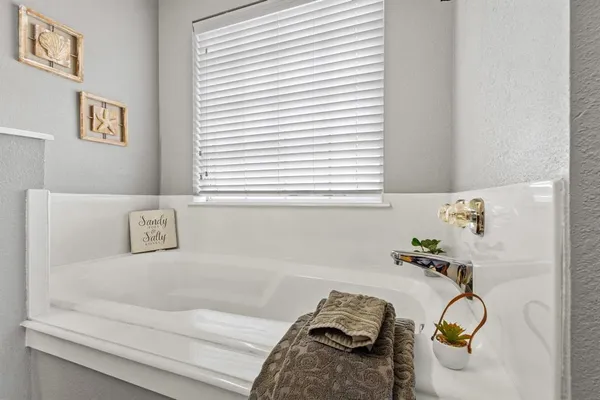 a bedroom with a bed and flat screen tv