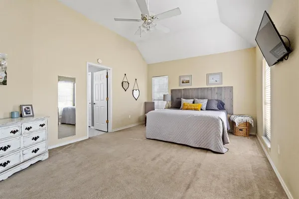 a view of a bedroom with baby crib and a window