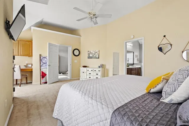 a bedroom with a bed mirror and a window