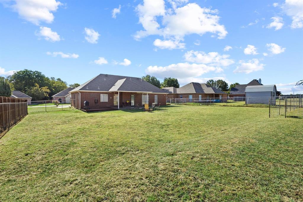 406 Sunshine Trail Bells, TX 75414 - Photo 32 of 37 a view of a house with a yard and sitting area