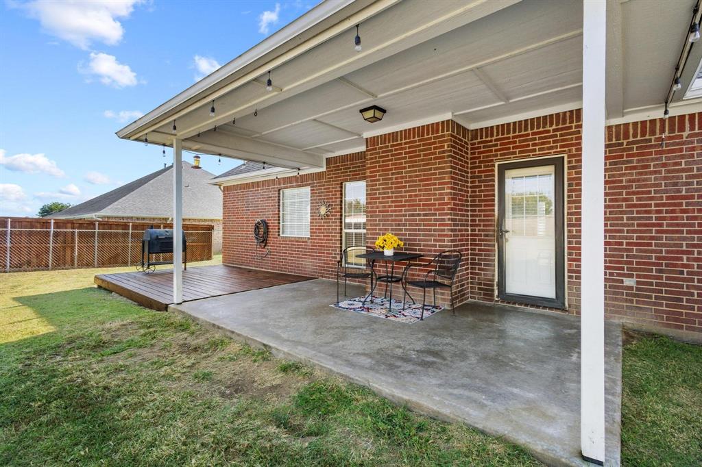 406 Sunshine Trail Bells, TX 75414 - Photo 4 of 36 a view of a porch with a table and chairs and potted plants