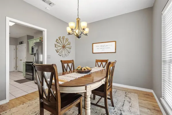a dining room with furniture a chandelier and window