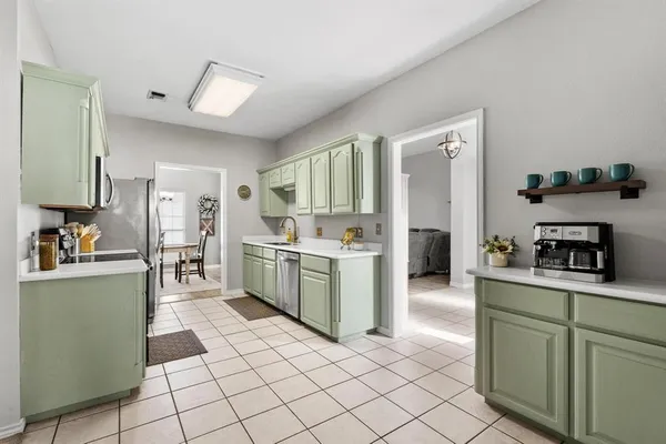 a kitchen with cabinets and window