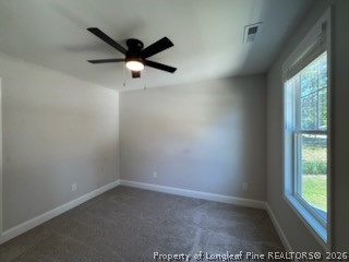 390 Summerhill Road Fayetteville, NC 28303 - Photo 15 of 27 an empty room with a window and a ceiling fan