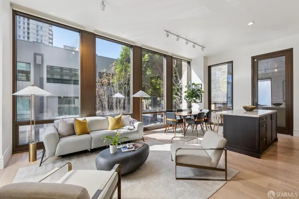 a living room with furniture and large windows