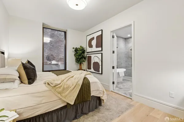 a bathroom with a painting on the wall and a shower